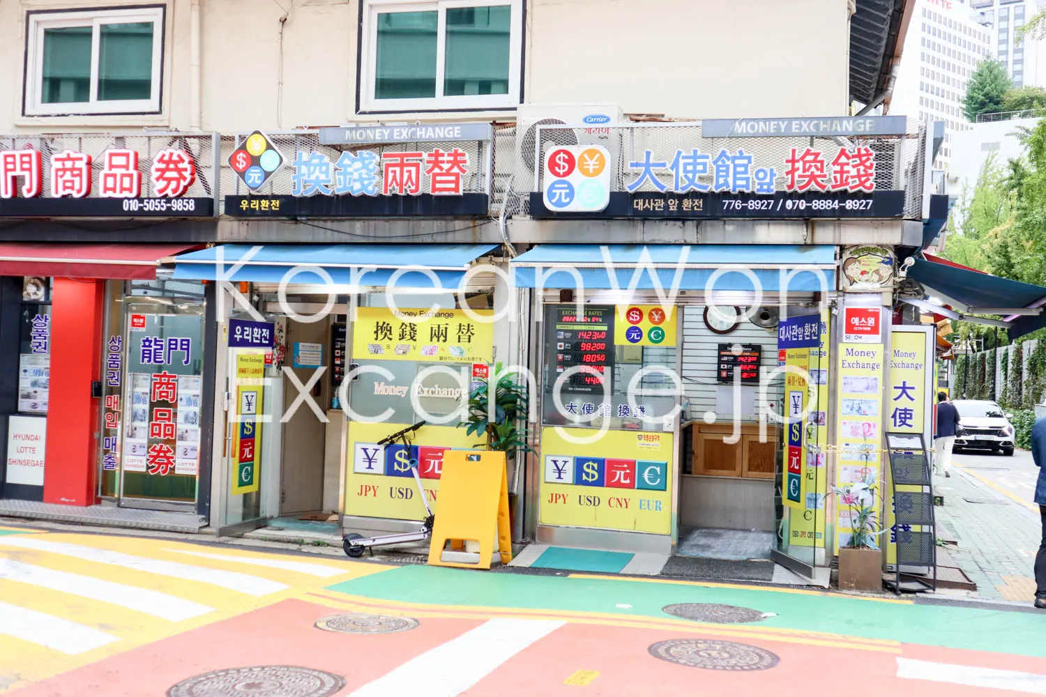A Seoul exchange-counter street, with signs reading "MONEY EXCHANGE", and Korean characters for money exchange, side by side.